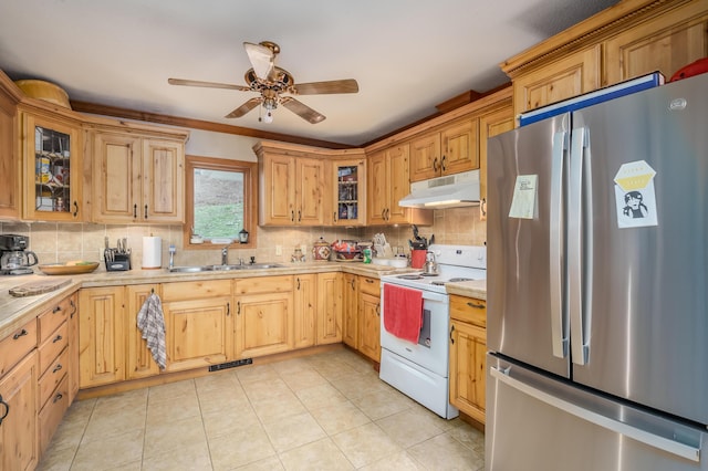 kitchen with backsplash, stainless steel fridge, sink, and white electric stove