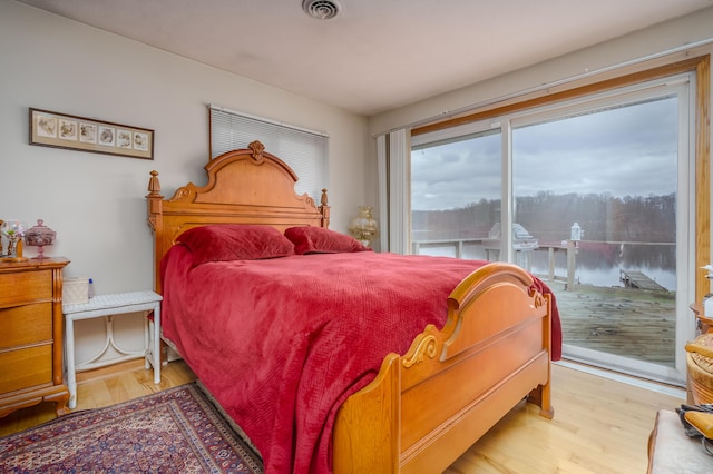 bedroom with access to outside and light hardwood / wood-style floors