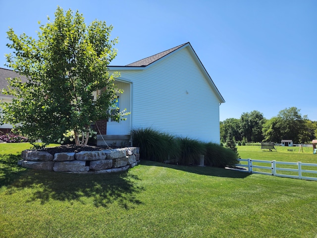 view of side of property featuring a yard