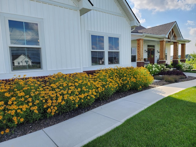 view of side of home with a lawn