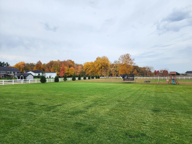 view of community featuring a yard and a rural view