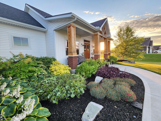 property exterior at dusk with a porch