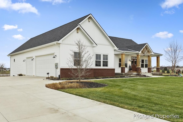 view of front of home featuring a porch, a front yard, and a garage