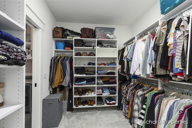 walk in closet with carpet flooring