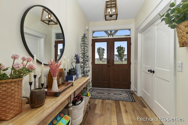 foyer with hardwood / wood-style floors and french doors