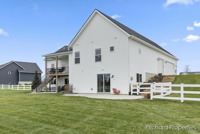 rear view of property featuring a lawn, a patio, and a wooden deck