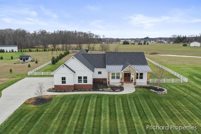 view of front of home featuring a front yard and a rural view