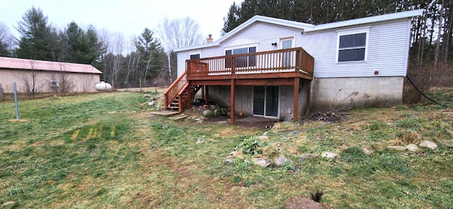 rear view of property featuring a lawn and a deck