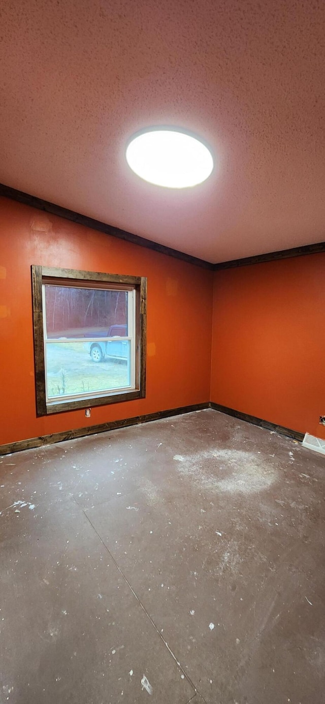 empty room featuring a textured ceiling