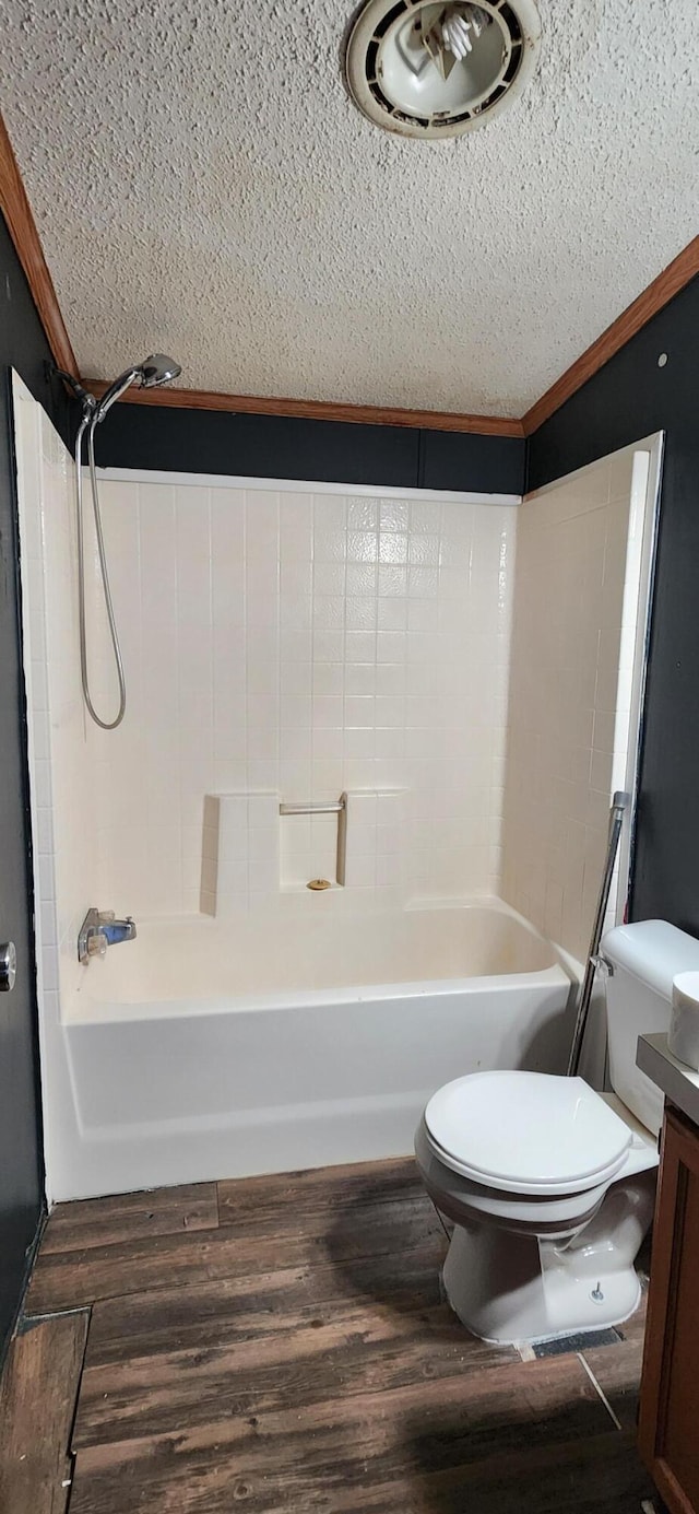 full bathroom with hardwood / wood-style floors, toilet, vanity, shower / bathtub combination, and ornamental molding