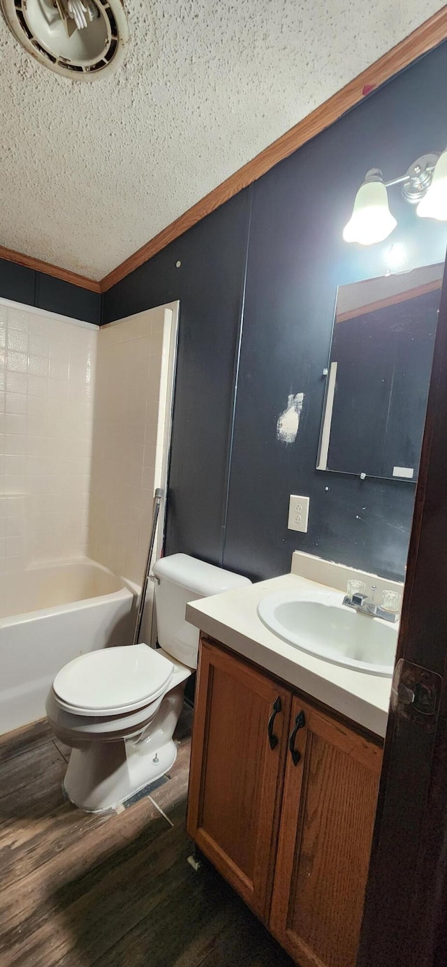 full bathroom with hardwood / wood-style floors, vanity, shower / tub combination, toilet, and ornamental molding