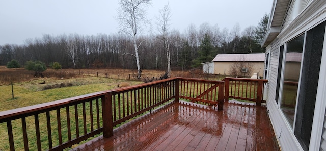 wooden terrace featuring a yard