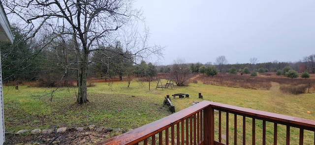 view of yard with a rural view and a wooden deck