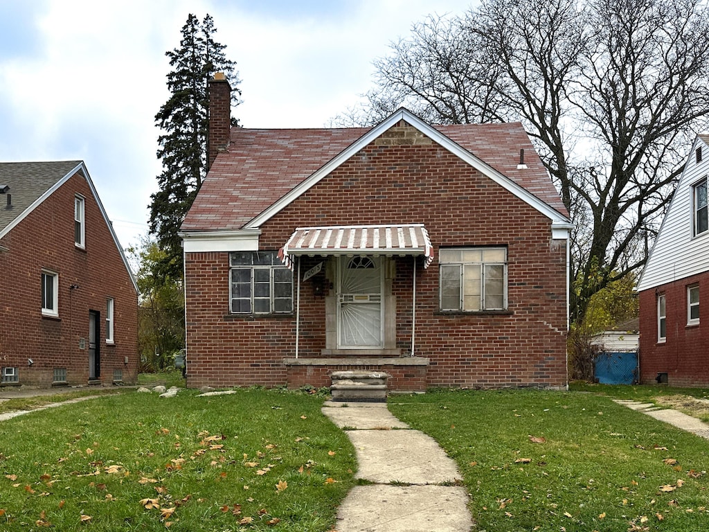 bungalow-style house with a front lawn