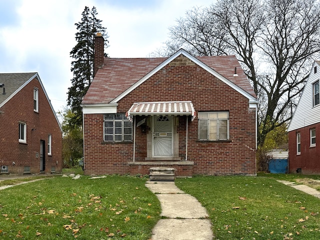 bungalow-style house with a front lawn