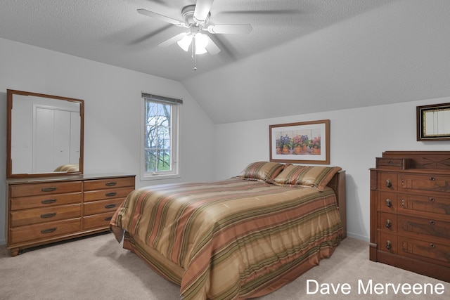 carpeted bedroom featuring a textured ceiling, ceiling fan, and lofted ceiling