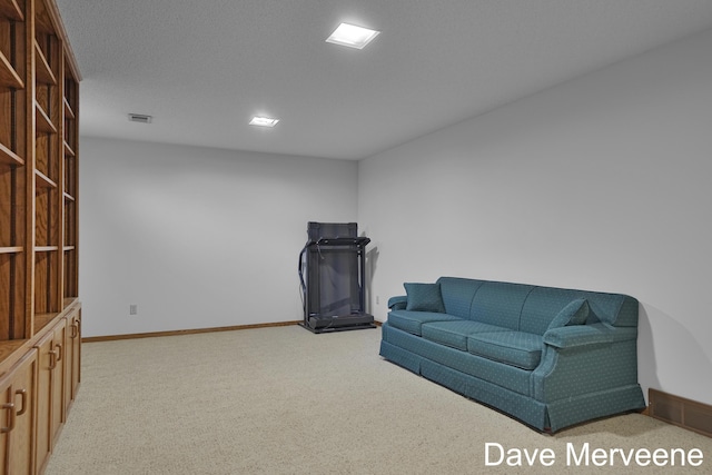 sitting room with carpet flooring and a textured ceiling