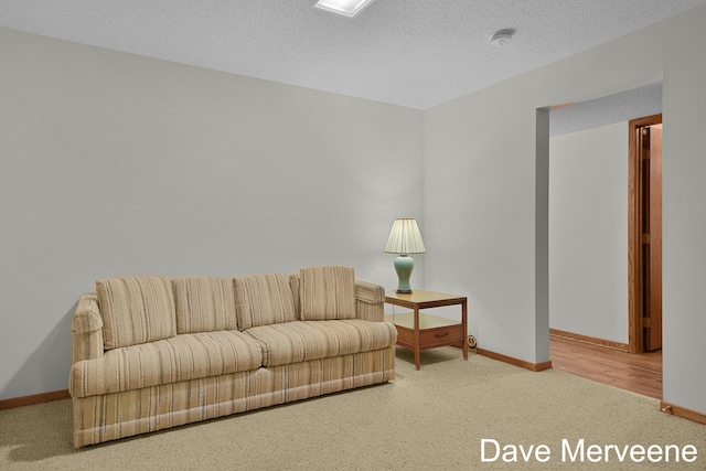 carpeted living room with a textured ceiling