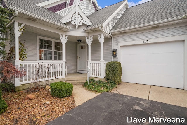 doorway to property with a porch and a garage