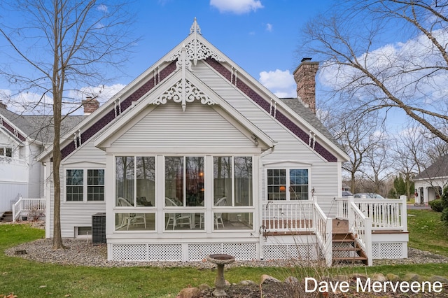 back of house featuring a sunroom