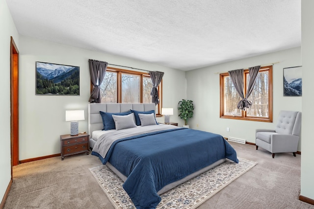 carpeted bedroom featuring a baseboard radiator and a textured ceiling