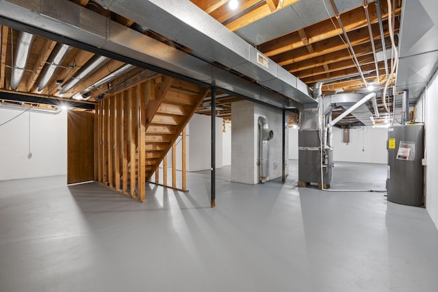 basement with heating unit and electric water heater