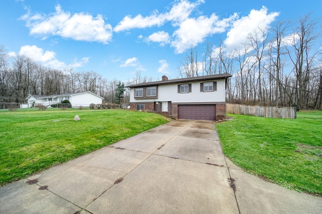 bi-level home with a garage and a front lawn