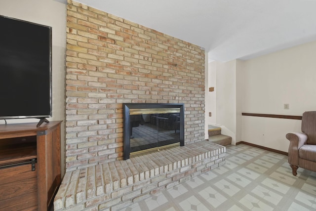 living room featuring a brick fireplace