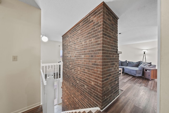 hall featuring a textured ceiling and dark wood-type flooring