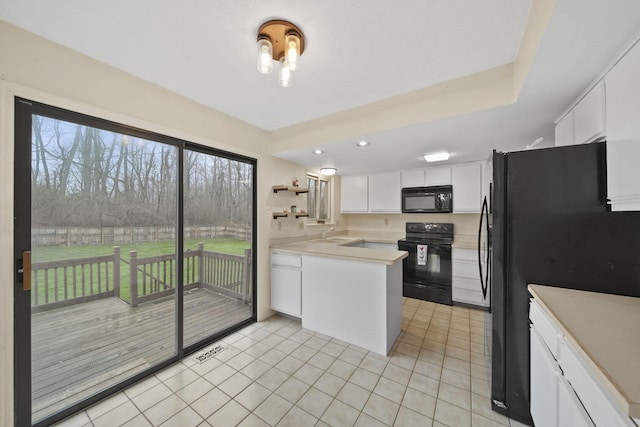 kitchen with white cabinetry, sink, light tile patterned floors, and black appliances