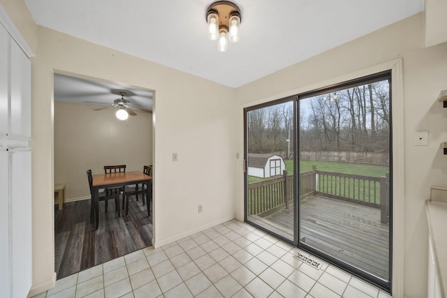 doorway featuring ceiling fan and light hardwood / wood-style floors