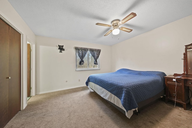 carpeted bedroom featuring ceiling fan, a textured ceiling, and a closet