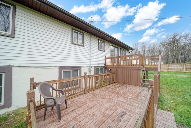 wooden deck featuring a yard