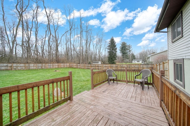 wooden terrace featuring a yard