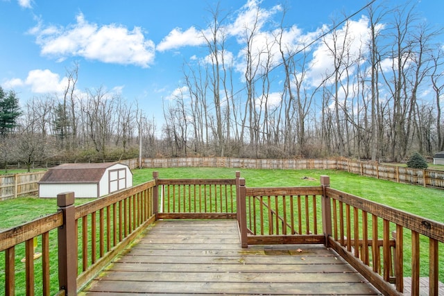 wooden deck with a shed and a lawn