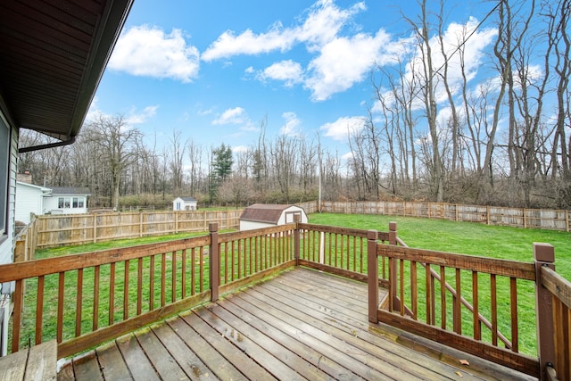 wooden terrace with a lawn and a storage shed