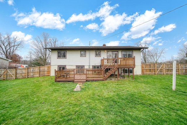 rear view of house featuring a yard and a wooden deck