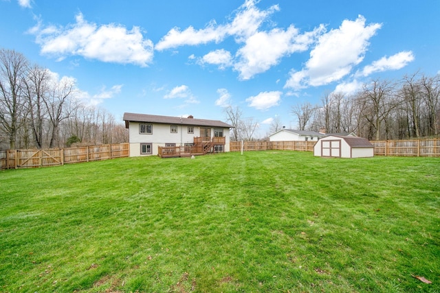 view of yard featuring a storage shed and a deck