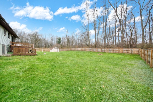 view of yard featuring a shed and a deck