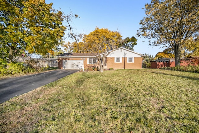 single story home featuring a front yard and a garage