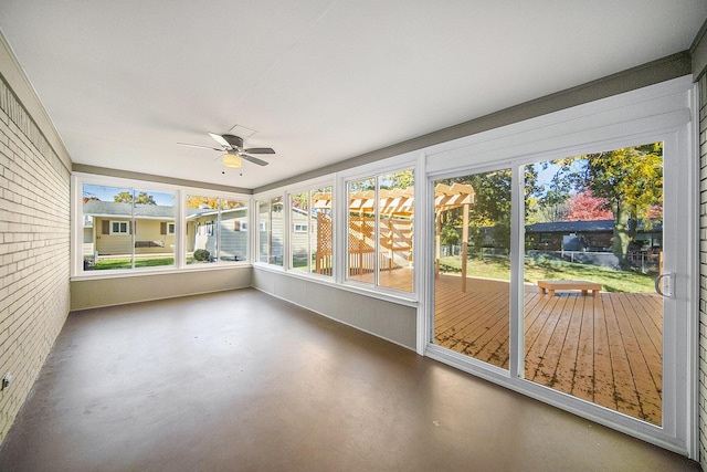 unfurnished sunroom with a wealth of natural light and ceiling fan