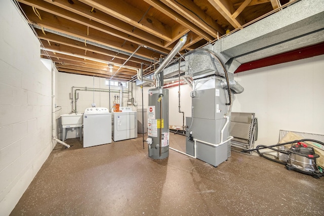 basement with heating unit, water heater, sink, and independent washer and dryer