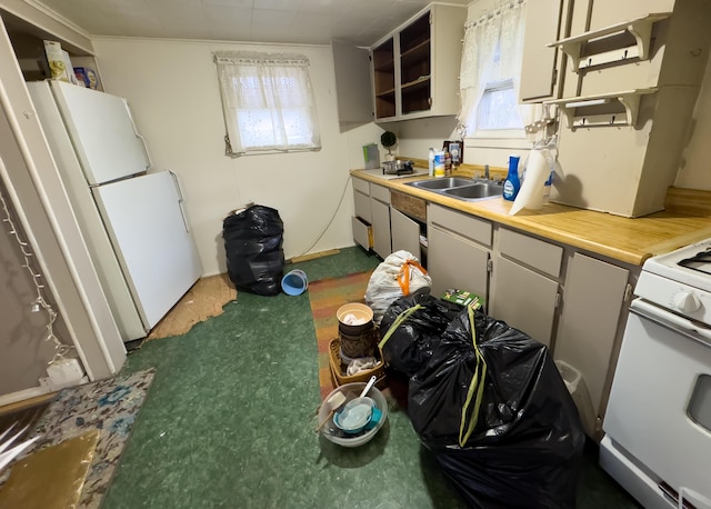 kitchen with dark carpet, white appliances, extractor fan, and sink