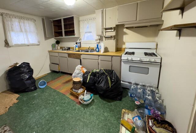 kitchen with sink and white range with gas stovetop