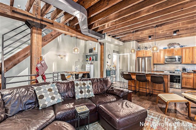 living room with ornate columns and beamed ceiling