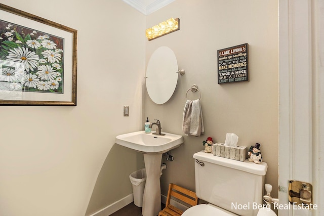 bathroom with toilet and ornamental molding