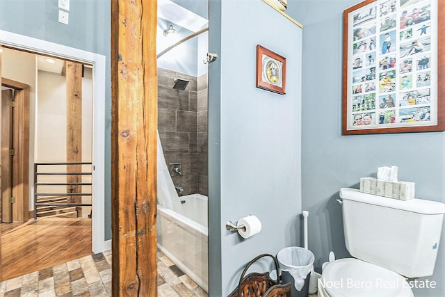 bathroom with wood-type flooring, shower / tub combo, and toilet