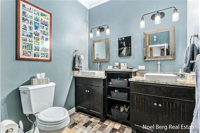 bathroom featuring crown molding, vanity, and toilet