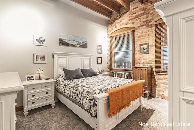 carpeted bedroom featuring beam ceiling and brick wall