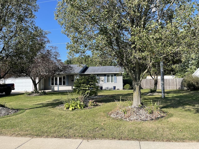 ranch-style house with a garage and a front lawn